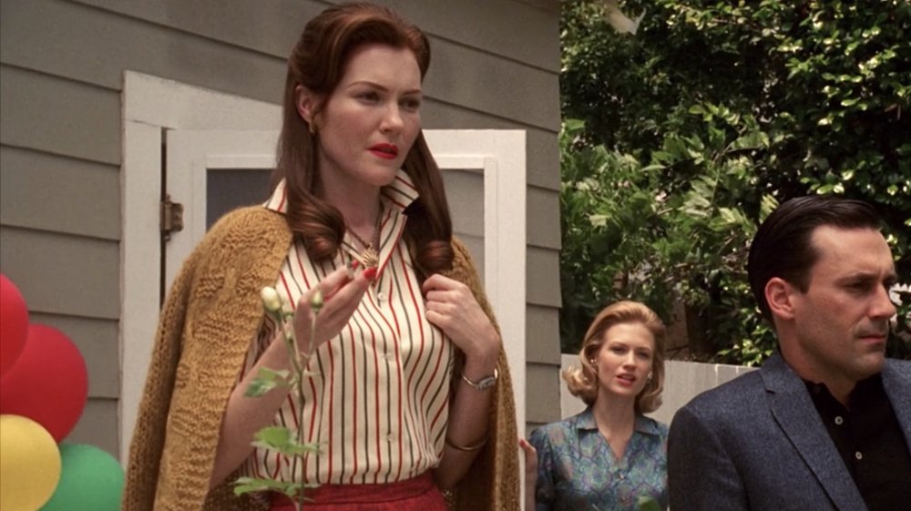 Darby Stanchfield as Helen Bishop, January Jones as Betty Draper and Jon Hamm as Don Draper in the garden on Mad Men
