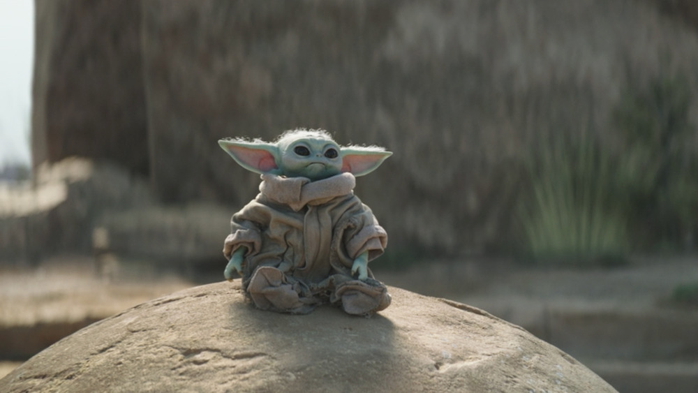 Baby Yoda/Grogu on the seeing stone in The Mandalorian