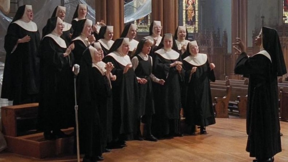 Deloris conducts choir